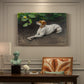 Canvas art print featuring a dog lying on ground with head raised in natural outdoor setting, presented within a refined interior setting