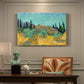 Canvas art print featuring rustic sheds surrounded by olive trees and tall cypresses in rural landscape, presented within a refined interior setting