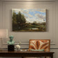 Canvas art print featuring figures washing clothes beside riverbank surrounded by trees, presented within a refined interior setting