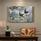 Canvas art print featuring a flock of birds in flight soaring across open sky above landscape, presented within a refined interior setting