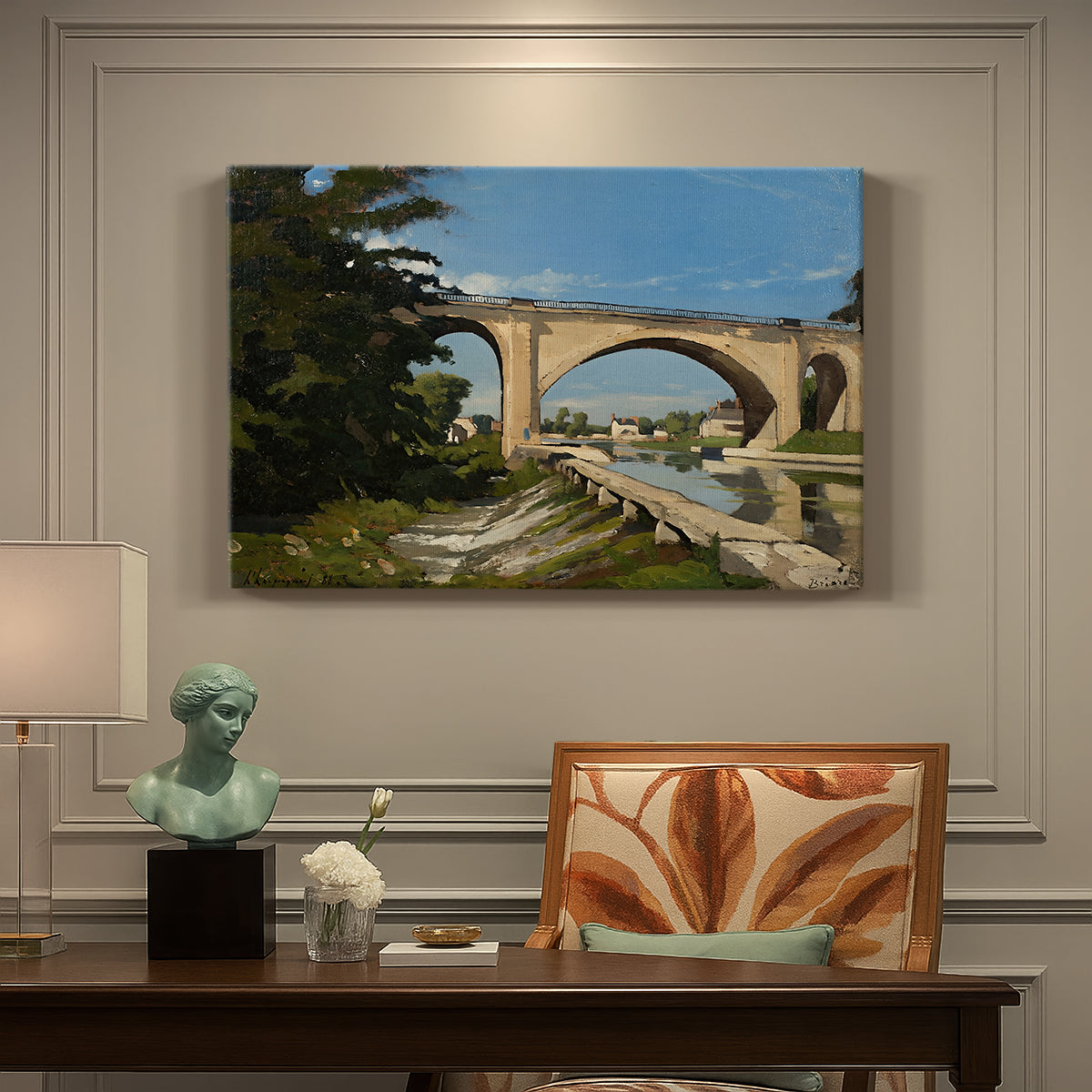 Canvas art print featuring an arched bridge spanning river with structure reflected in water, presented within a refined interior setting