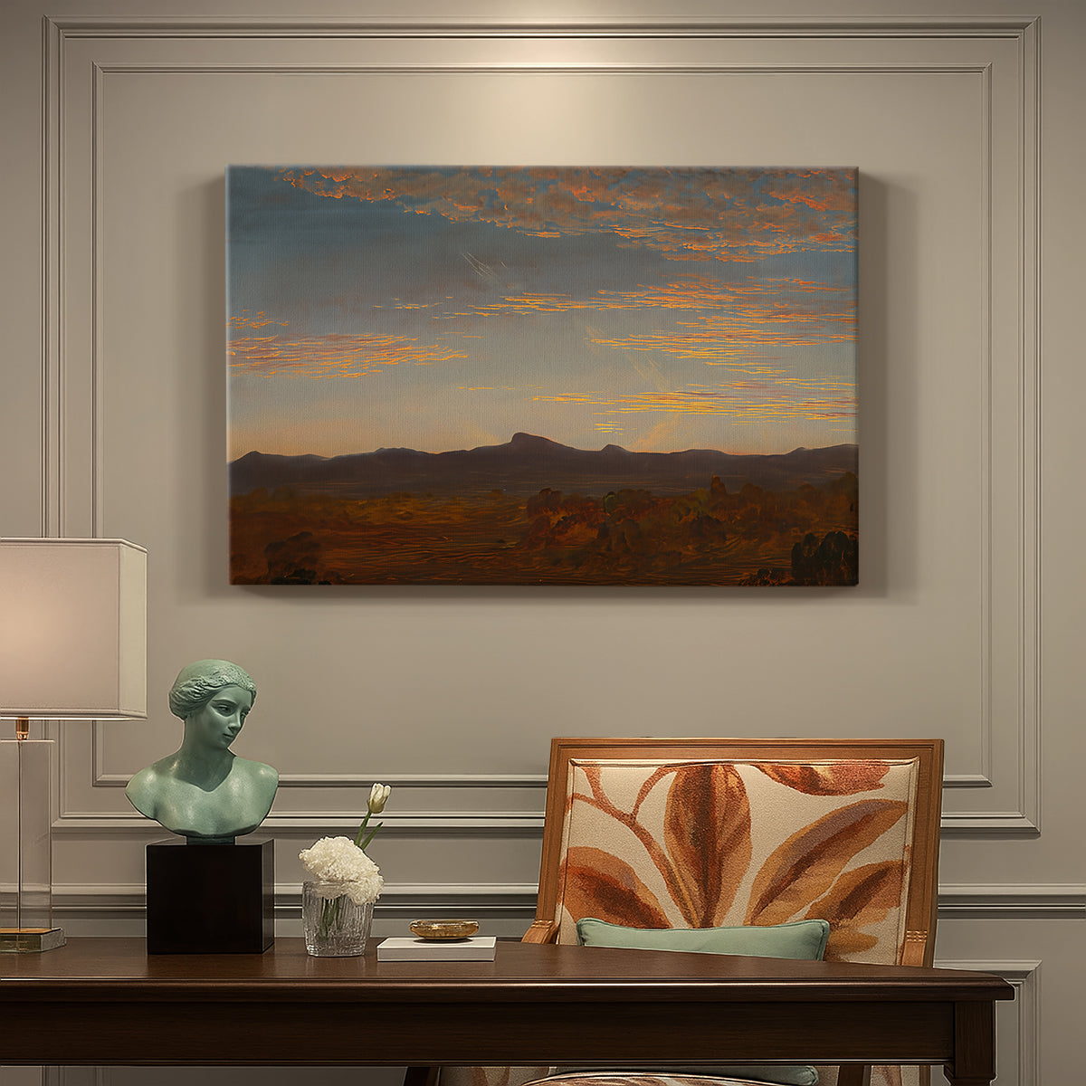 Canvas art print featuring a low mountain landscape under warm sky with broad open foreground, presented within a refined interior setting