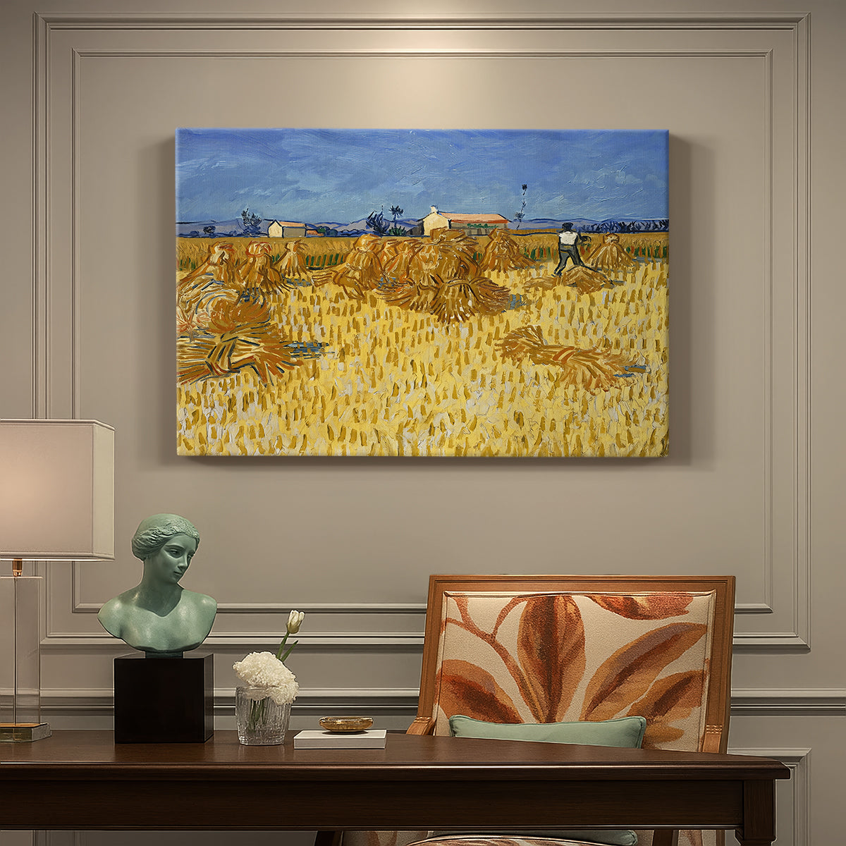 Canvas art print featuring stacked bundles of wheat arranged across harvested field under open sky, presented within a refined interior setting