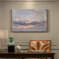 Canvas art print featuring a sky filled with warm sunset clouds over low horizon, presented within a refined interior setting