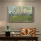 Canvas art print featuring an orchard in bloom with pink blossoms across soft landscape, presented within a refined interior setting