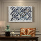 Canvas art print featuring a repeating floral design with flowing stems and scattered blossoms across light background, presented within a refined interior setting