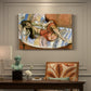 Canvas art print featuring a reclining woman resting on patterned textiles in a decorative interior, presented within a refined interior setting