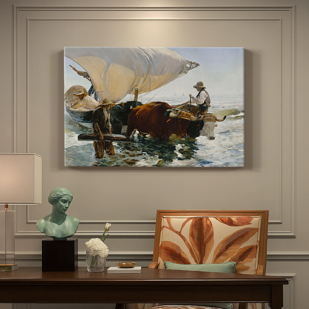 Canvas art print featuring fishermen pulling boat ashore with oxen along beach, presented within a refined interior setting