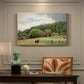 Canvas art print featuring cows grazing in pasture near farmhouse in rural countryside, presented within a refined interior setting