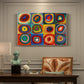 Canvas art print featuring a grid of squares each containing concentric circular color patterns, presented within a refined interior setting