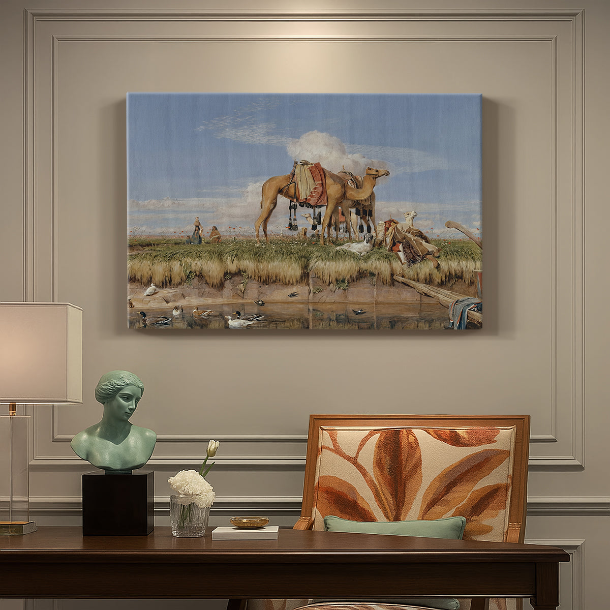 Canvas art print featuring figures and animals along riverbank with desert landscape, presented within a refined interior setting