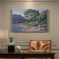 Canvas art print featuring figures bathing along shoreline in bright coastal landscape, presented within a refined interior setting