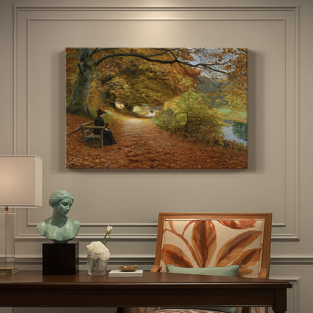 Canvas art print featuring figures walking along forest path covered in autumn leaves, presented within a refined interior setting