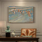 Canvas art print featuring children playing along shoreline with waves and wet sand, presented within a refined interior setting