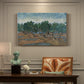 Canvas art print featuring twisting olive trees set within rolling landscape under vibrant sky, presented within a refined interior setting