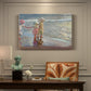 Canvas art print featuring three women standing together on beach in flowing dresses, presented within a refined interior setting