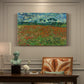 Canvas art print featuring a field dotted with red poppies stretching across green landscape, presented within a refined interior setting