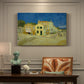 Canvas art print featuring a street view with bright yellow house and neighboring buildings under blue sky, presented within a refined interior setting