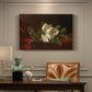 Canvas art print featuring a white magnolia bloom resting on red velvet surface, presented within a refined interior setting
