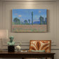 Canvas art print featuring an expansive field of red poppies with tall trees under blue sky, presented within a refined interior setting