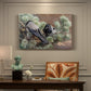 Canvas art print featuring two crows perched on ground among grass and earth tones, presented within a refined interior setting