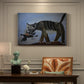 Canvas art print featuring an abstract cat lunging toward bird in angular form, presented within a refined interior setting