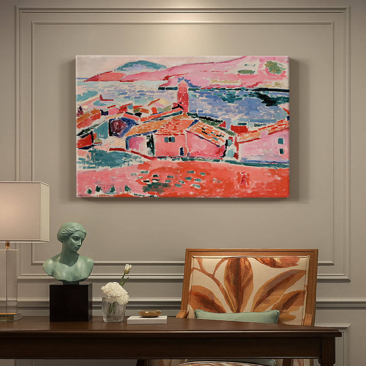 Canvas art print featuring a colorful coastal townscape with buildings, water, and bright rooftops, presented within a refined interior setting