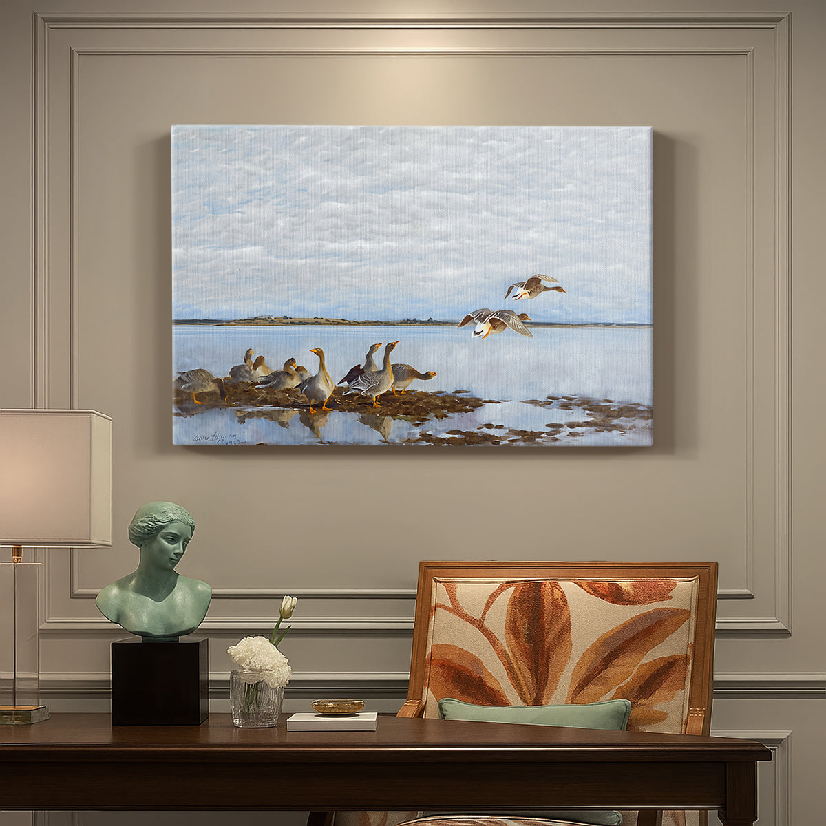 Canvas art print featuring a group of geese gathered near water in a natural wetland landscape, presented within a refined interior setting
