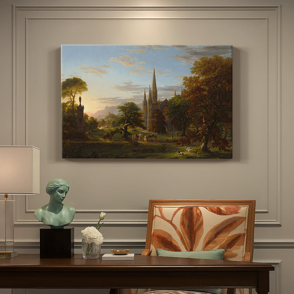 Canvas art print featuring figures approaching settlement within expansive landscape under warm light, presented within a refined interior setting