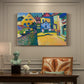 Canvas art print featuring a village street with colorful houses and trees lining a narrow road, presented within a refined interior setting