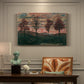 Canvas art print featuring four trees standing in open landscape against colorful sky, presented within a refined interior setting