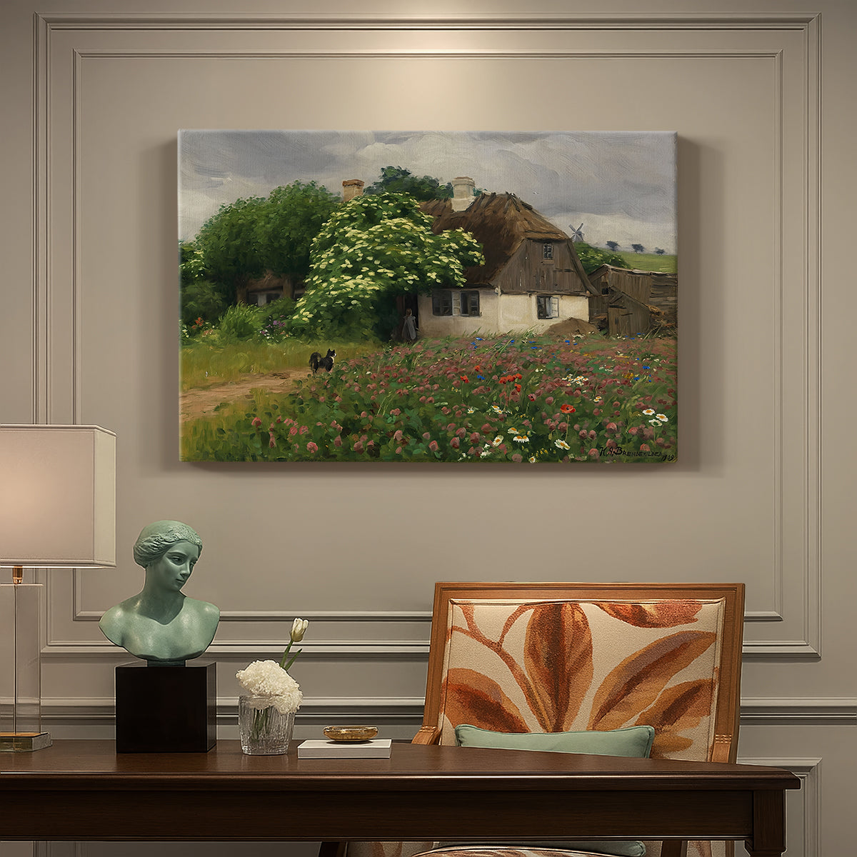 Canvas art print featuring a farmhouse surrounded by meadow filled with wildflowers and greenery, presented within a refined interior setting