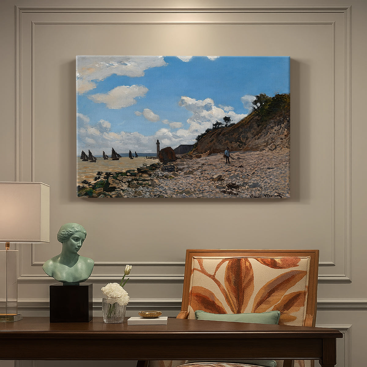 Canvas art print featuring a coastal beach scene with figures gathered along shoreline and boats nearby, presented within a refined interior setting