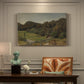 Canvas art print featuring a rolling landscape with fields, trees, and distant water under open sky, presented within a refined interior setting