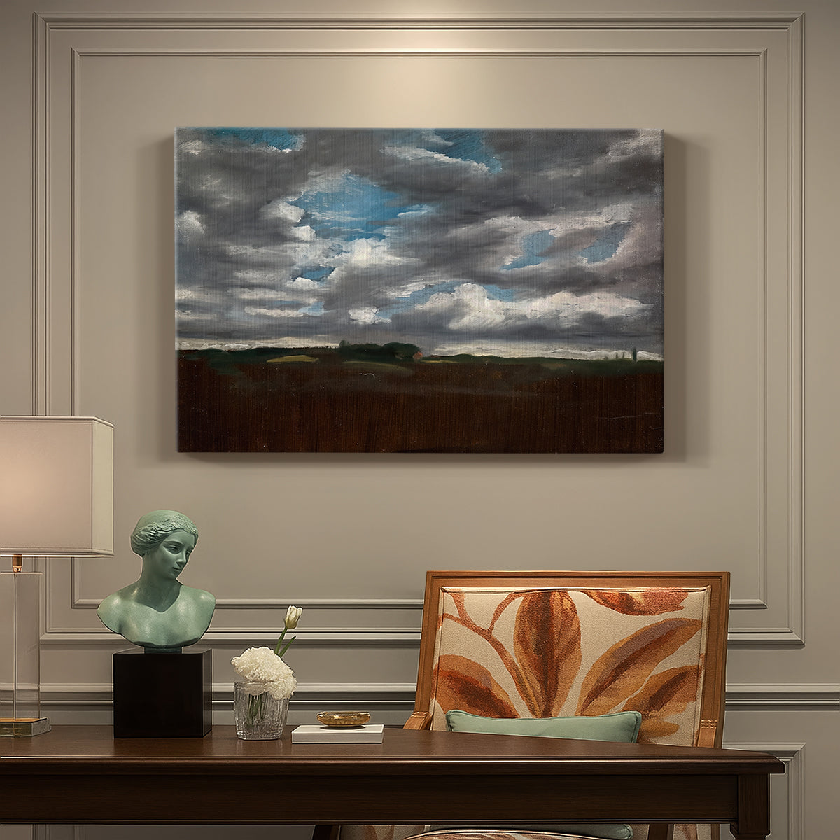 Canvas art print featuring a wide landscape beneath heavy grey clouds, presented within a refined interior setting