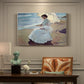 Canvas art print featuring a woman seated on beach in flowing white dress beside water, presented within a refined interior setting