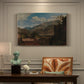 Canvas art print featuring a mountain landscape with town and river under dramatic sky, presented within a refined interior setting