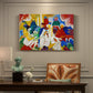 Canvas art print featuring a colorful abstract composition with clustered shapes suggesting figures and decorative elements, presented within a refined interior setting