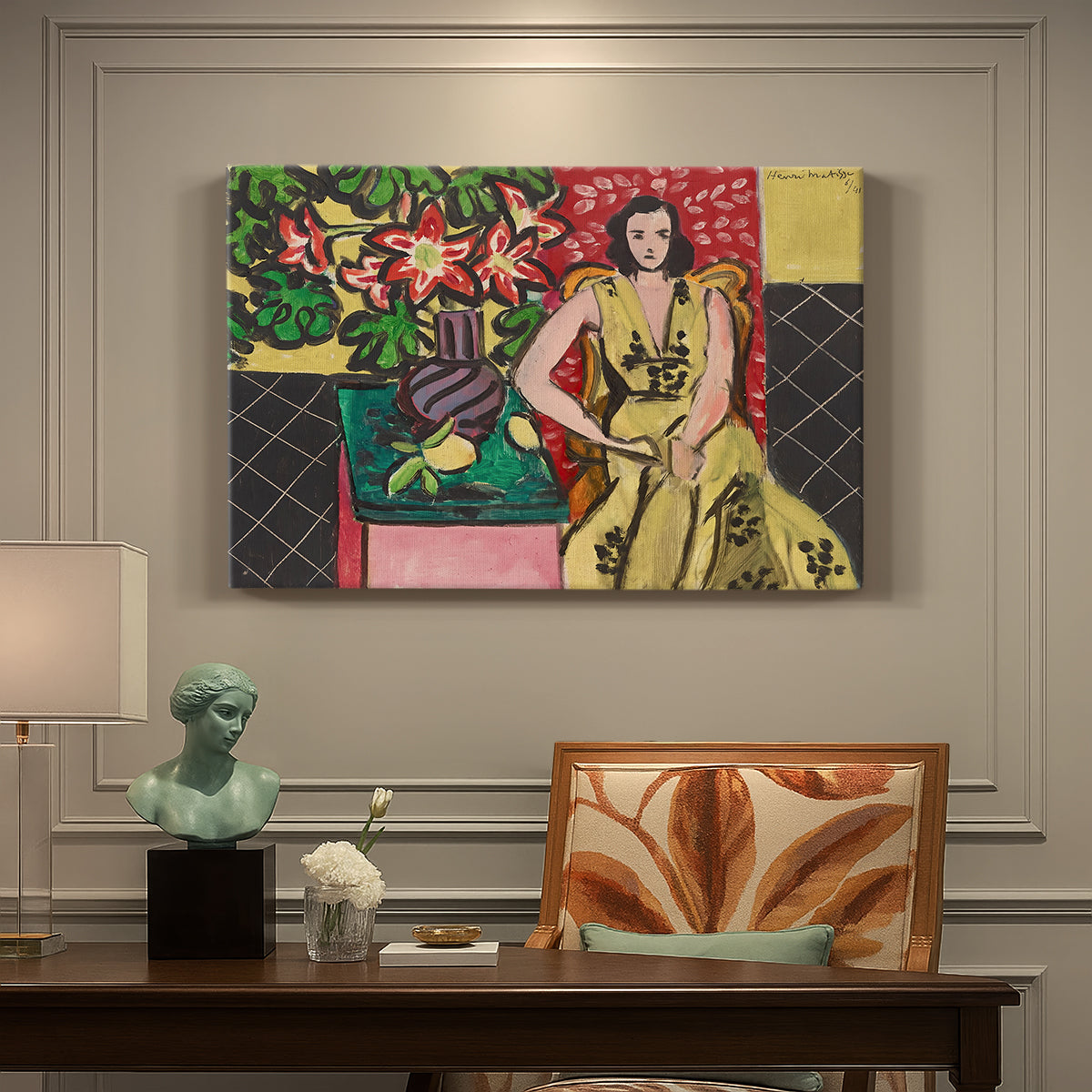 Canvas art print featuring a seated woman beside a vase of amaryllis in a richly patterned interior, presented within a refined interior setting