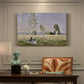 Canvas art print featuring a woman seated in grassy field beneath tree in bright summer landscape, presented within a refined interior setting