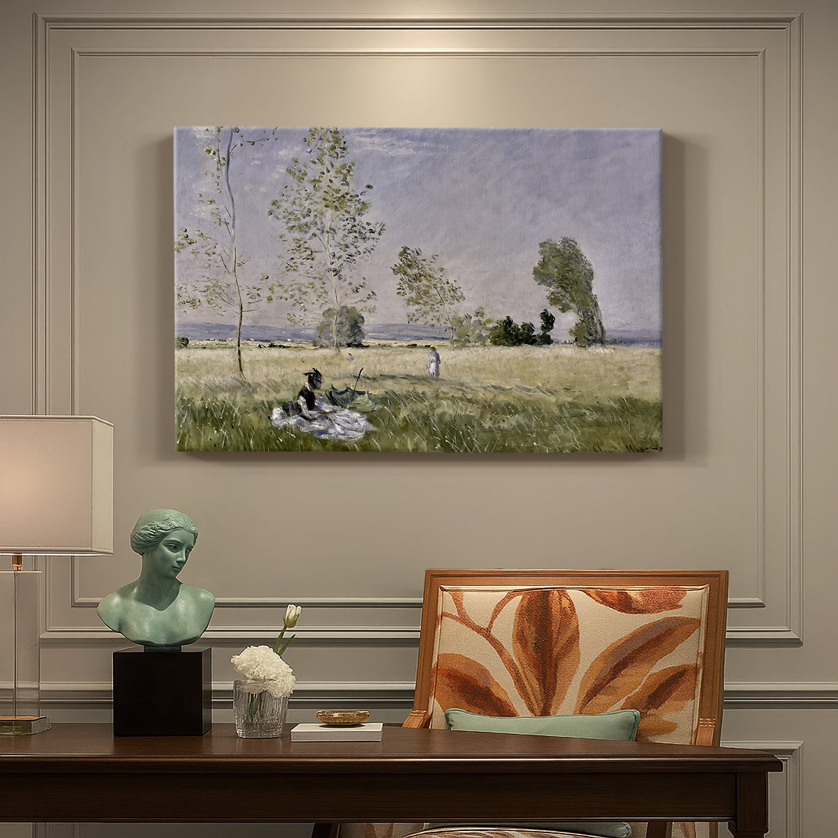 Canvas art print featuring a woman seated in grassy field beneath tree in bright summer landscape, presented within a refined interior setting
