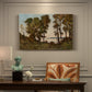 Canvas art print featuring a riverbank lined with trees and vegetation beside calm flowing water, presented within a refined interior setting