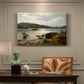Canvas art print featuring figures and boats gathered along shoreline in calm coastal setting, presented within a refined interior setting