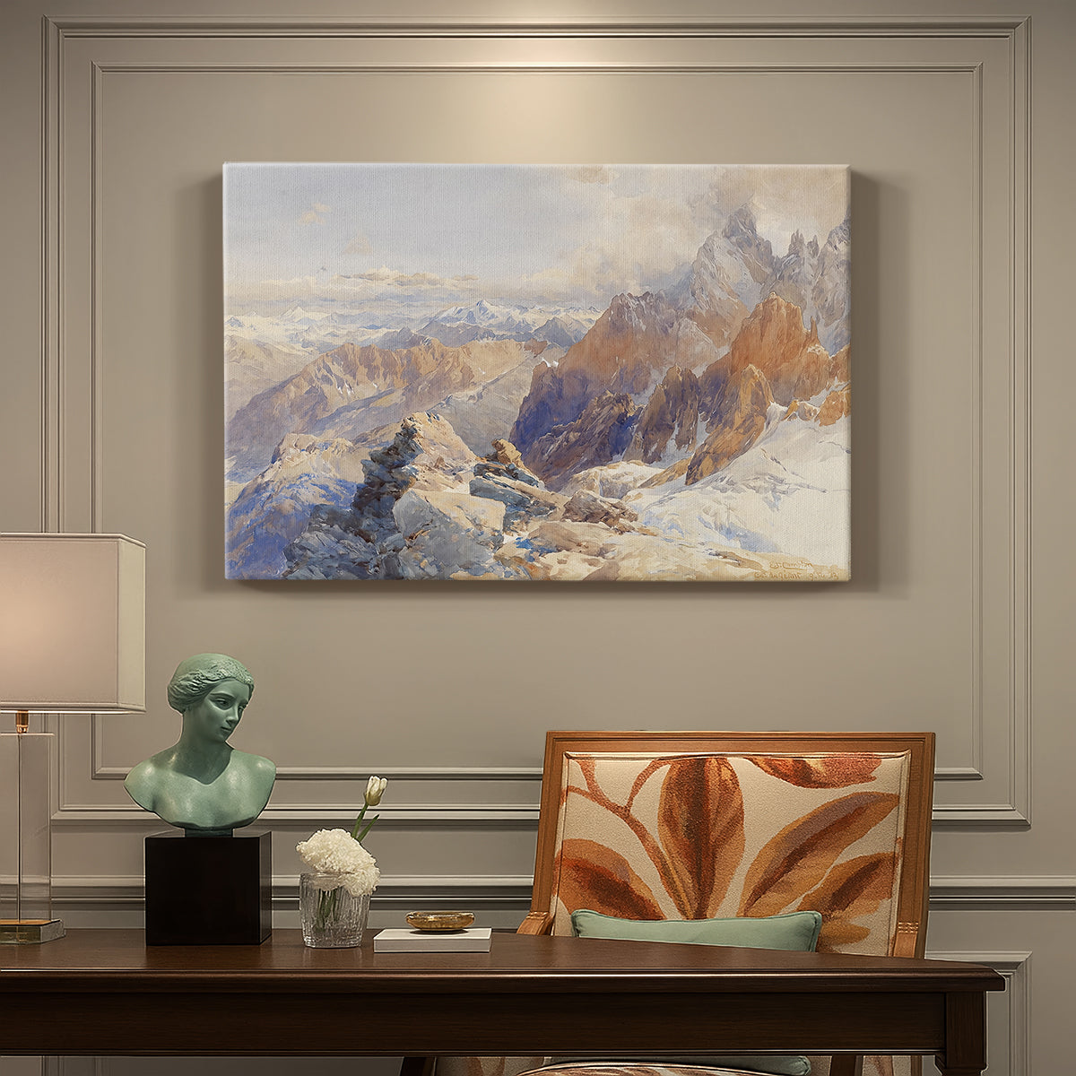 Canvas art print featuring a mountain pass with snow-covered peaks and expansive alpine valley, presented within a refined interior setting