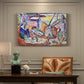 Canvas art print featuring figures lounging outdoors in a vibrant coastal setting with water views, presented within a refined interior setting