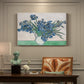 Canvas art print featuring a cluster of irises blooming with flowing brushstrokes and vivid color, presented within a refined interior setting