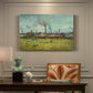 Canvas art print featuring industrial buildings with smokestacks rising above flat landscape, presented within a refined interior setting
