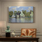 Canvas art print featuring a row of houses along river with reflections in calm water, presented within a refined interior setting