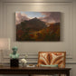 Canvas art print featuring a mountain landscape clearing after storm with sunlight breaking through clouds, presented within a refined interior setting