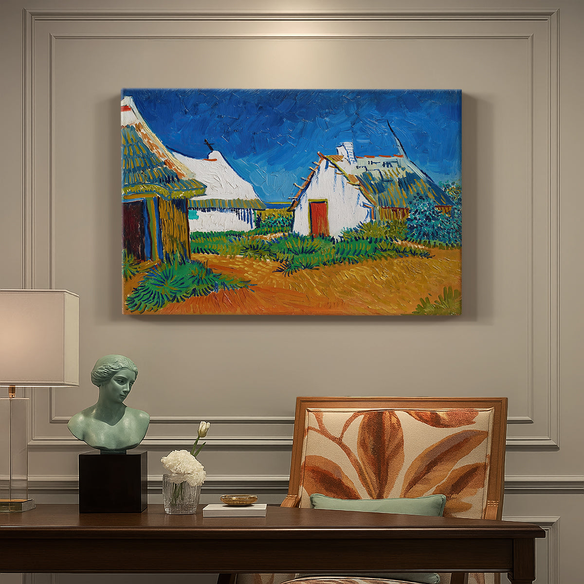 Canvas art print featuring white cottages grouped together with bold colors and surrounding landscape, presented within a refined interior setting